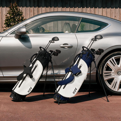 5-way stand bag with 4 pockets staged at clubhouse entrance classic aesthetic